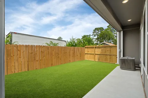 a view of an house with backyard and porch