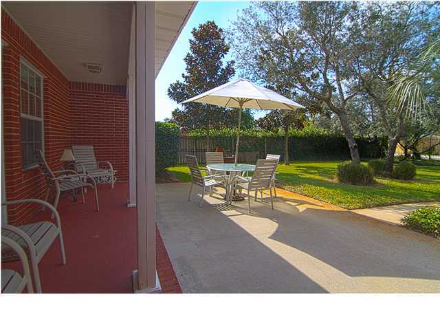 3927 Mesa Road Destin, FL 32541 - Photo 15 of 16 a backyard of a house with table and chairs