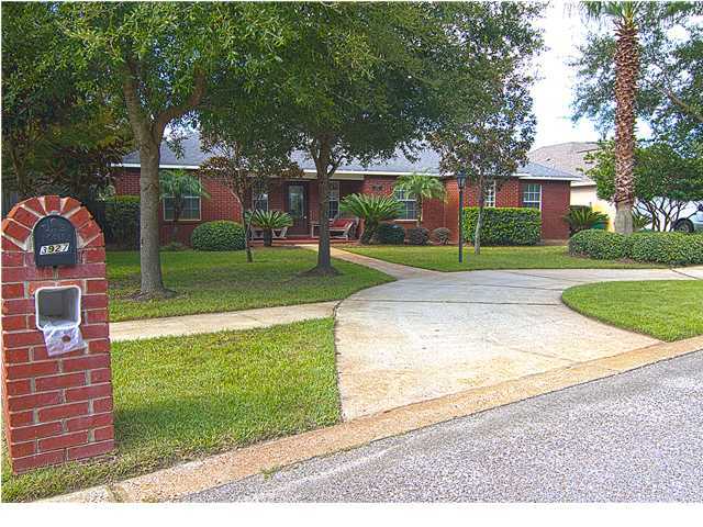 3927 Mesa Road Destin, FL 32541 - Photo 2 of 16 a front view of a house with a yard and garage