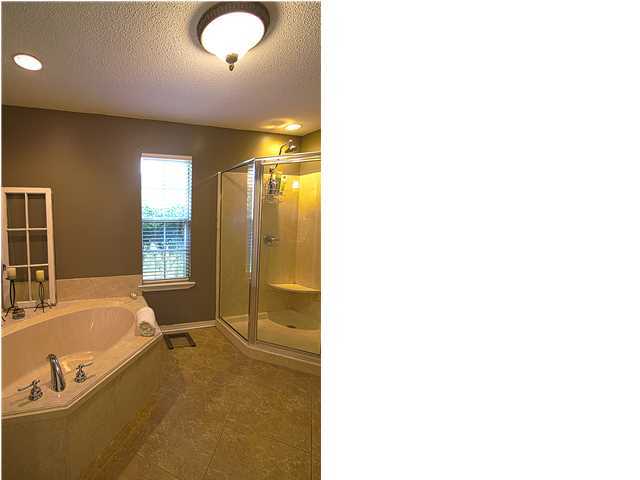 3927 Mesa Road Destin, FL 32541 - Photo 7 of 16 a bathroom with a tub sink and mirror
