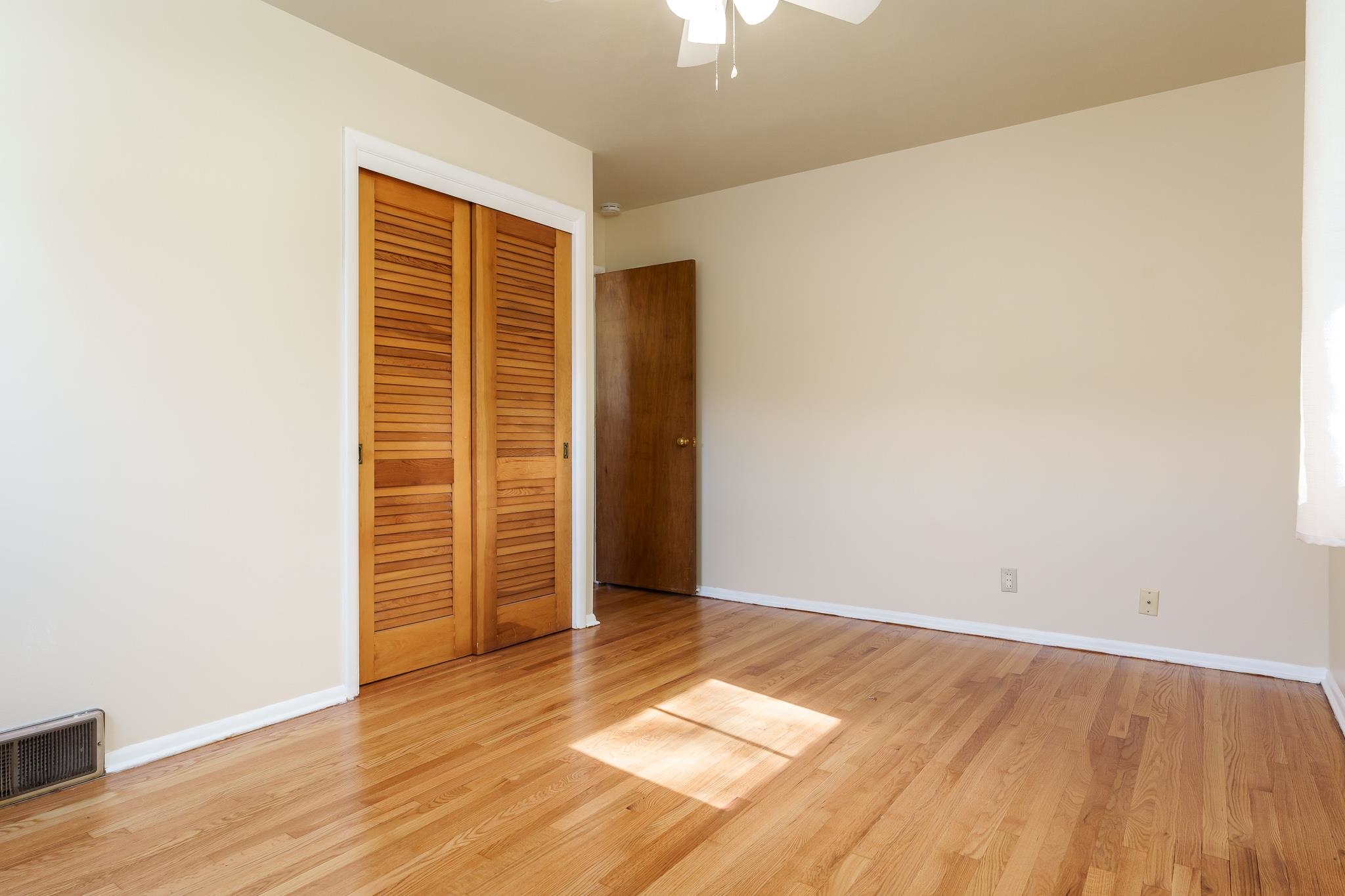 3332 Wesleyan Avenue Rockford, IL 61108 - Photo 11 of 45 an empty room with wooden floor and windows