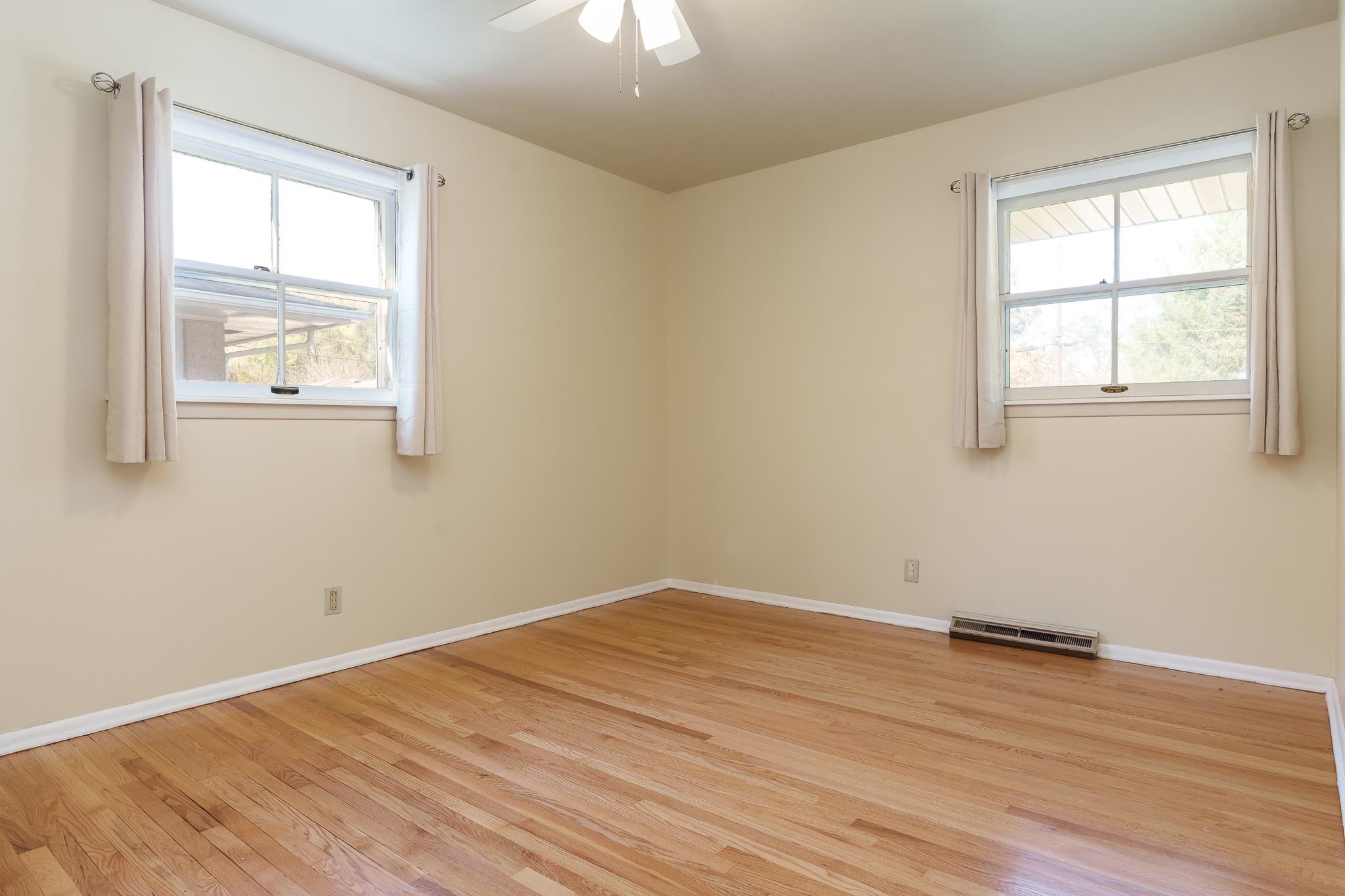 3332 Wesleyan Avenue Rockford, IL 61108 - Photo 12 of 45 an empty room with wooden floor and windows