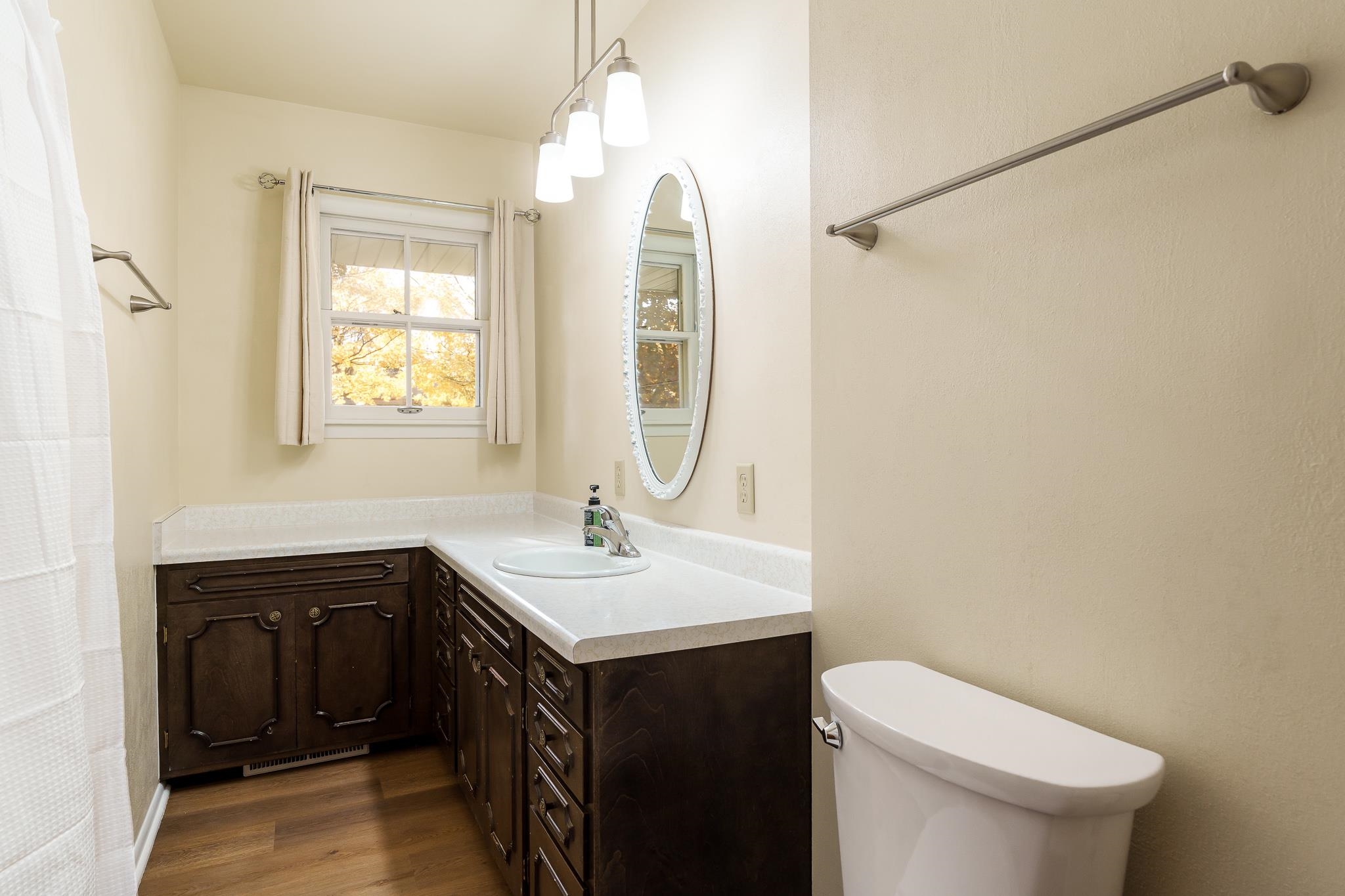 3332 Wesleyan Avenue Rockford, IL 61108 - Photo 16 of 45 a bathroom with a sink a toilet and mirror