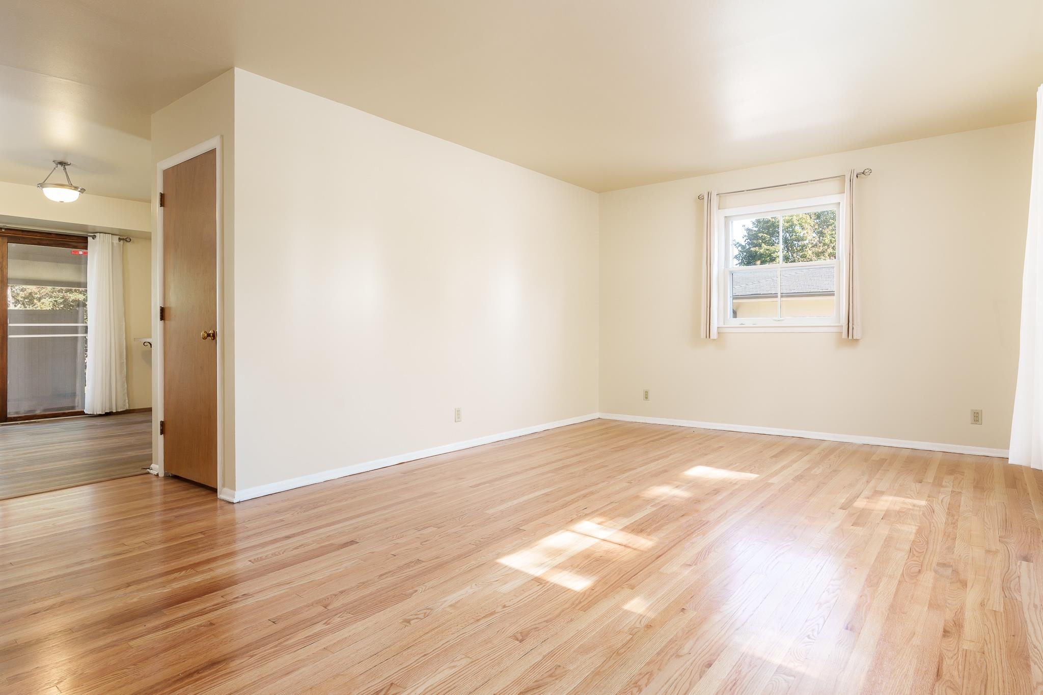 3332 Wesleyan Avenue Rockford, IL 61108 - Photo 5 of 45 a view of an empty room with wooden floor and a window