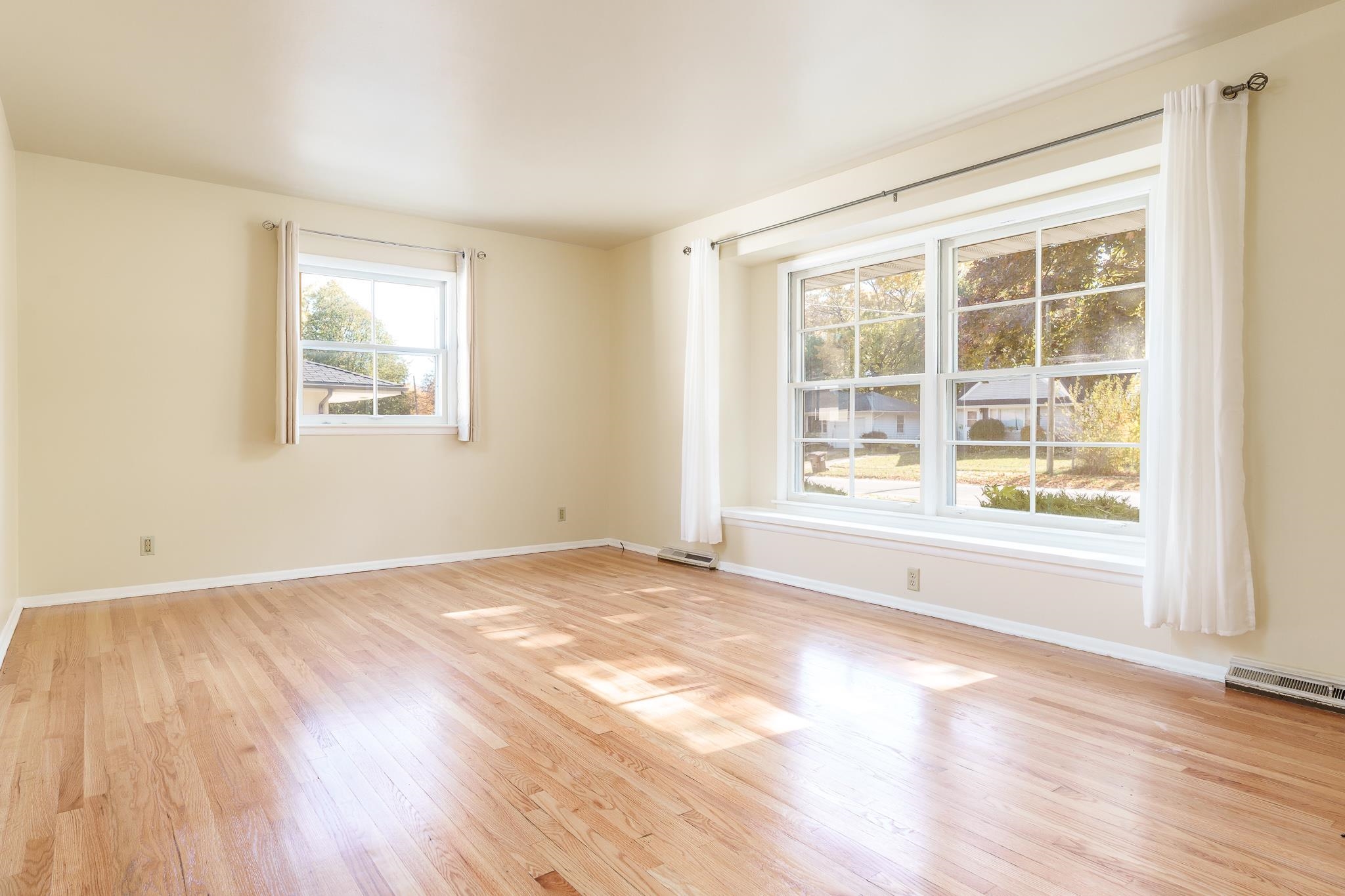 3332 Wesleyan Avenue Rockford, IL 61108 - Photo 6 of 45 a view of an empty room with wooden floor and a window