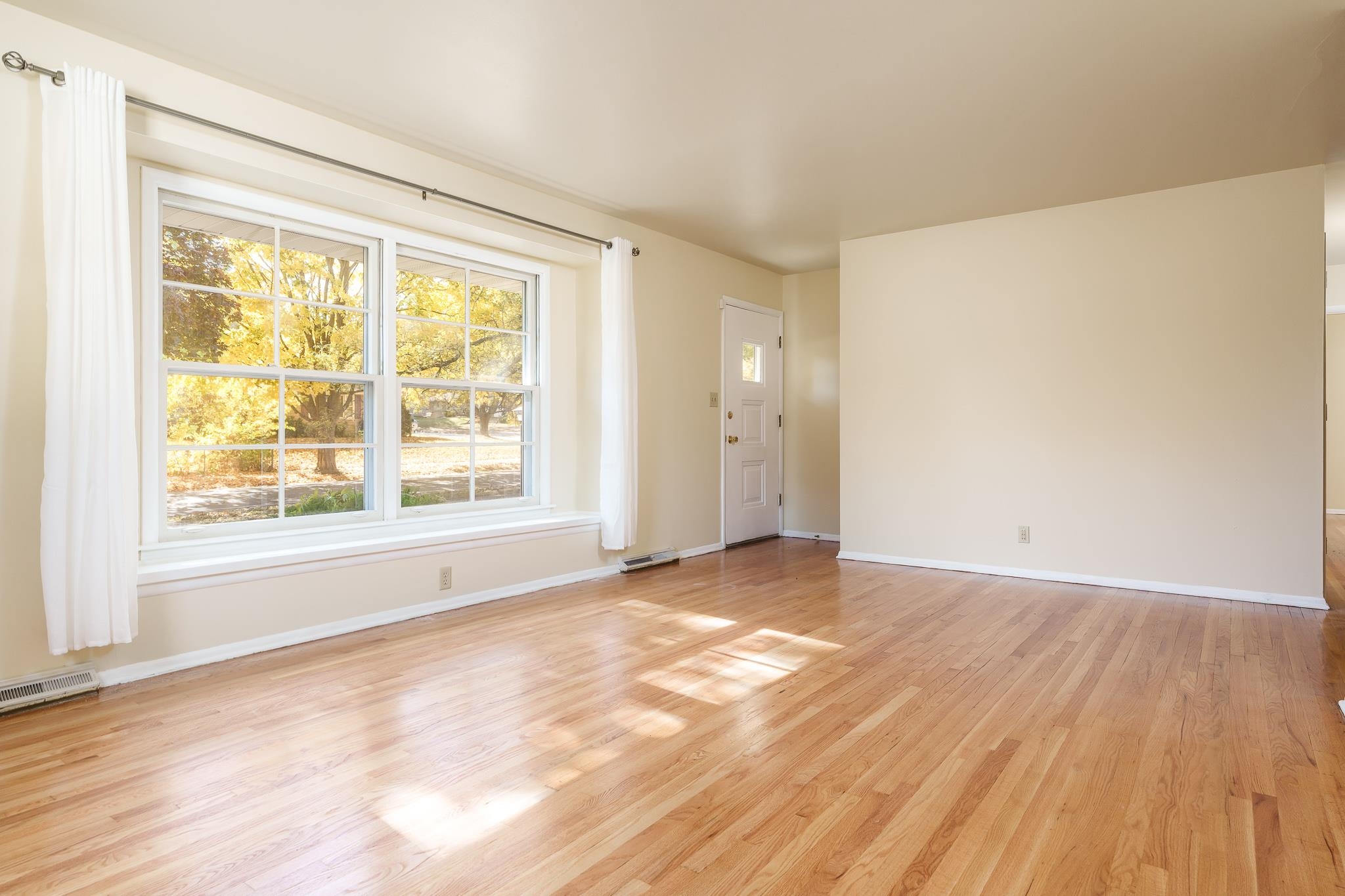 3332 Wesleyan Avenue Rockford, IL 61108 - Photo 8 of 45 a view of an empty room with wooden floor and a window