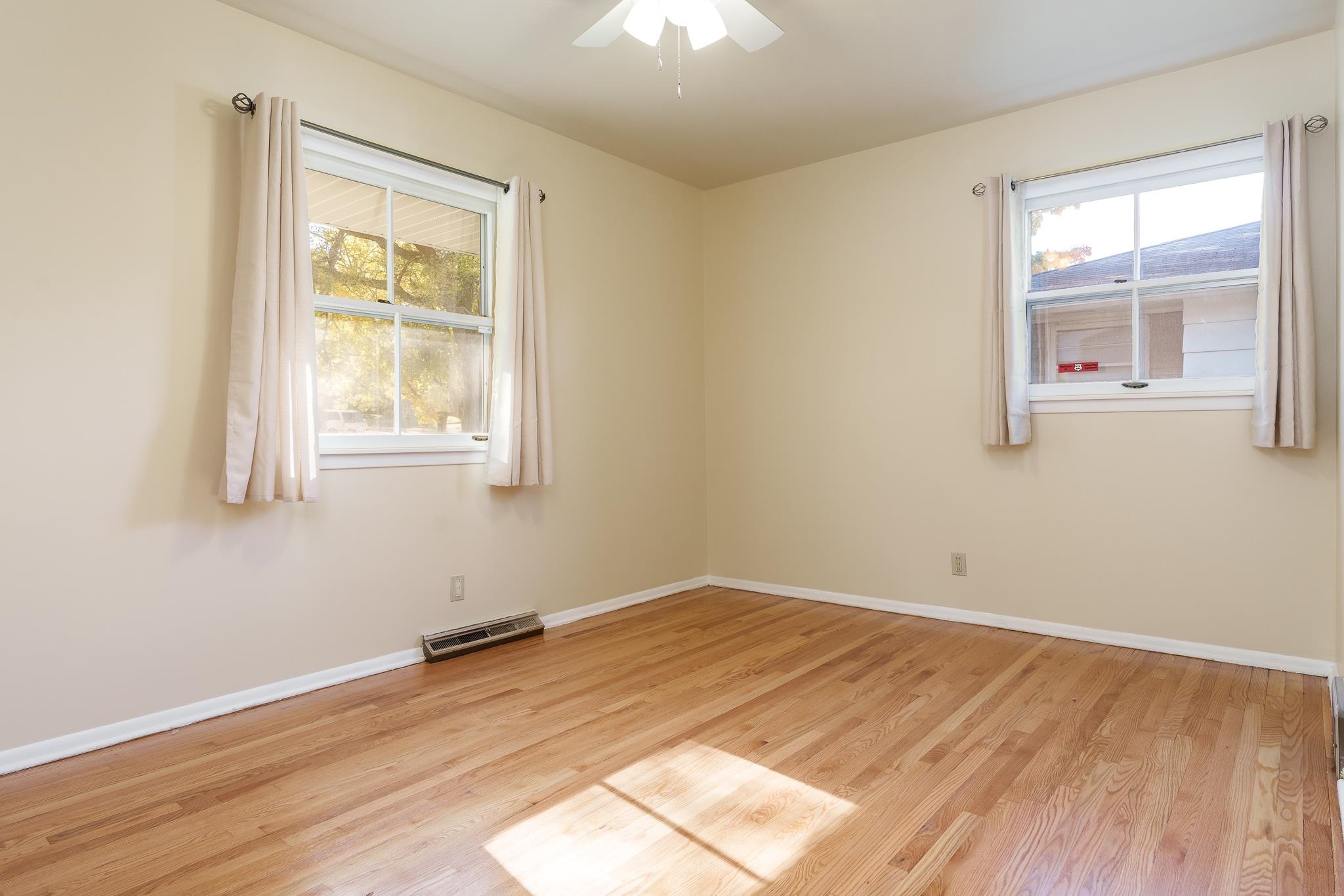 3332 Wesleyan Avenue Rockford, IL 61108 - Photo 9 of 45 an empty room with wooden floor and windows
