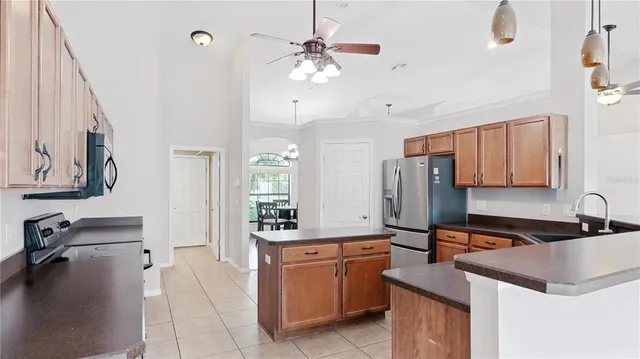 a kitchen with a sink refrigerator and cabinets
