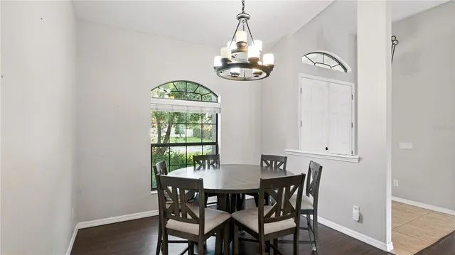 a view of a dining room with a table and chairs