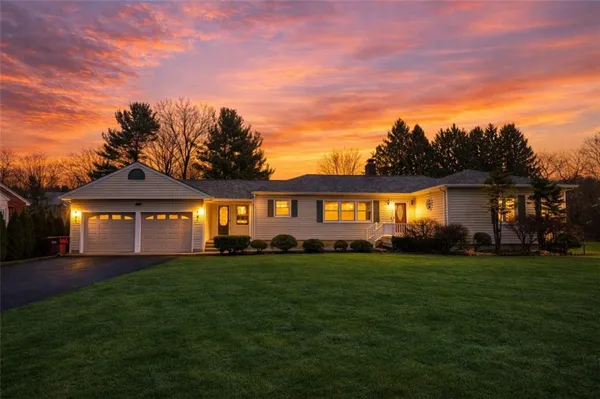 a front view of a house with a garden
