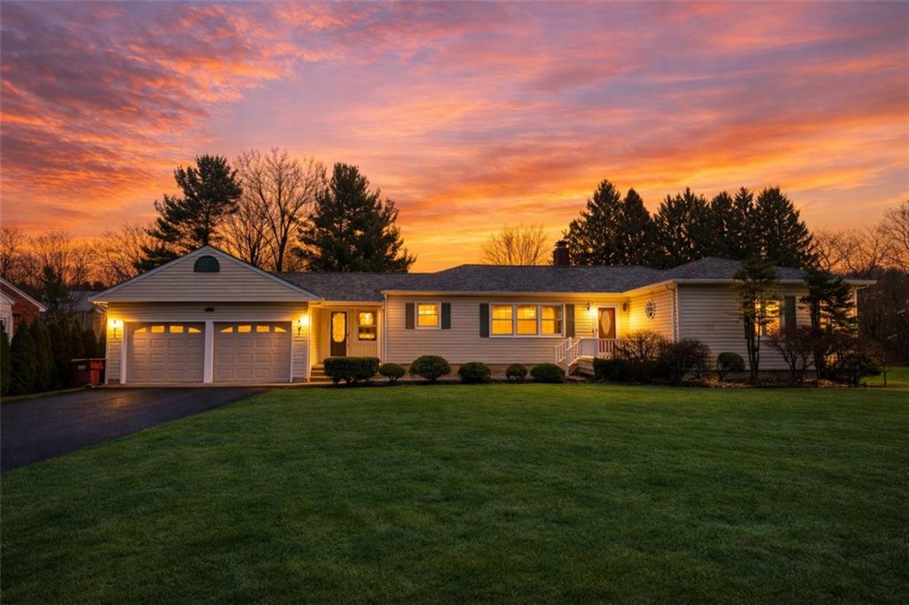 a front view of a house with a garden