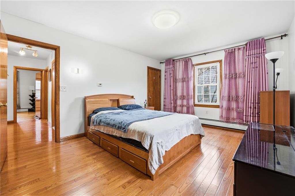 460 North Maple Street Mercer, PA 16137 - Photo 12 of 32 a bedroom with a bed and wooden floor