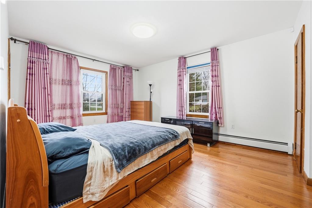 460 North Maple Street Mercer, PA 16137 - Photo 13 of 32 a bedroom with a bed and wooden floor