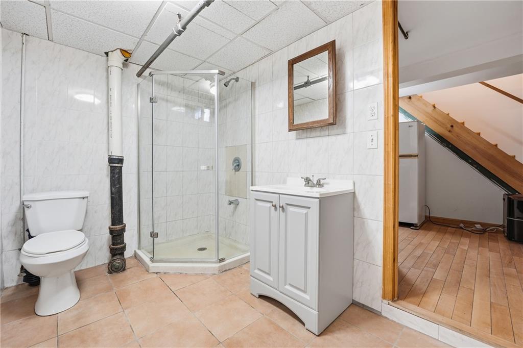 460 North Maple Street Mercer, PA 16137 - Photo 26 of 32 a bathroom with a granite countertop sink a toilet and shower