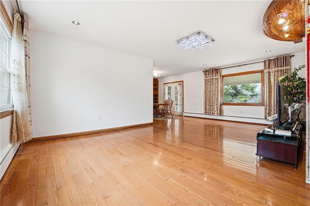 460 North Maple Street Mercer, PA 16137 - Photo 5 of 32 a view of an empty room with wooden floor and a window