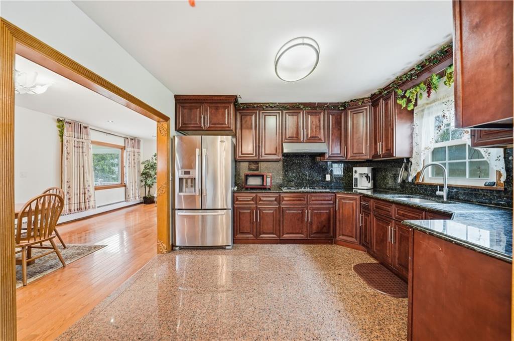 460 North Maple Street Mercer, PA 16137 - Photo 9 of 32 a kitchen with stainless steel appliances granite countertop a refrigerator stove top oven and sink