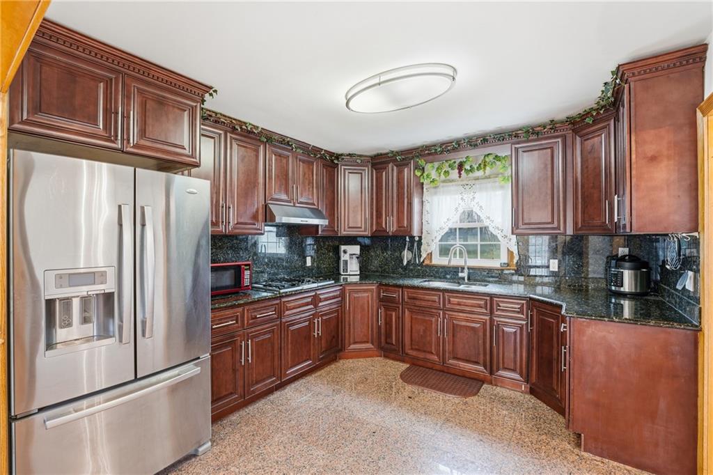 460 North Maple Street Mercer, PA 16137 - Photo 10 of 32 a kitchen with stainless steel appliances granite countertop a refrigerator sink and cabinets