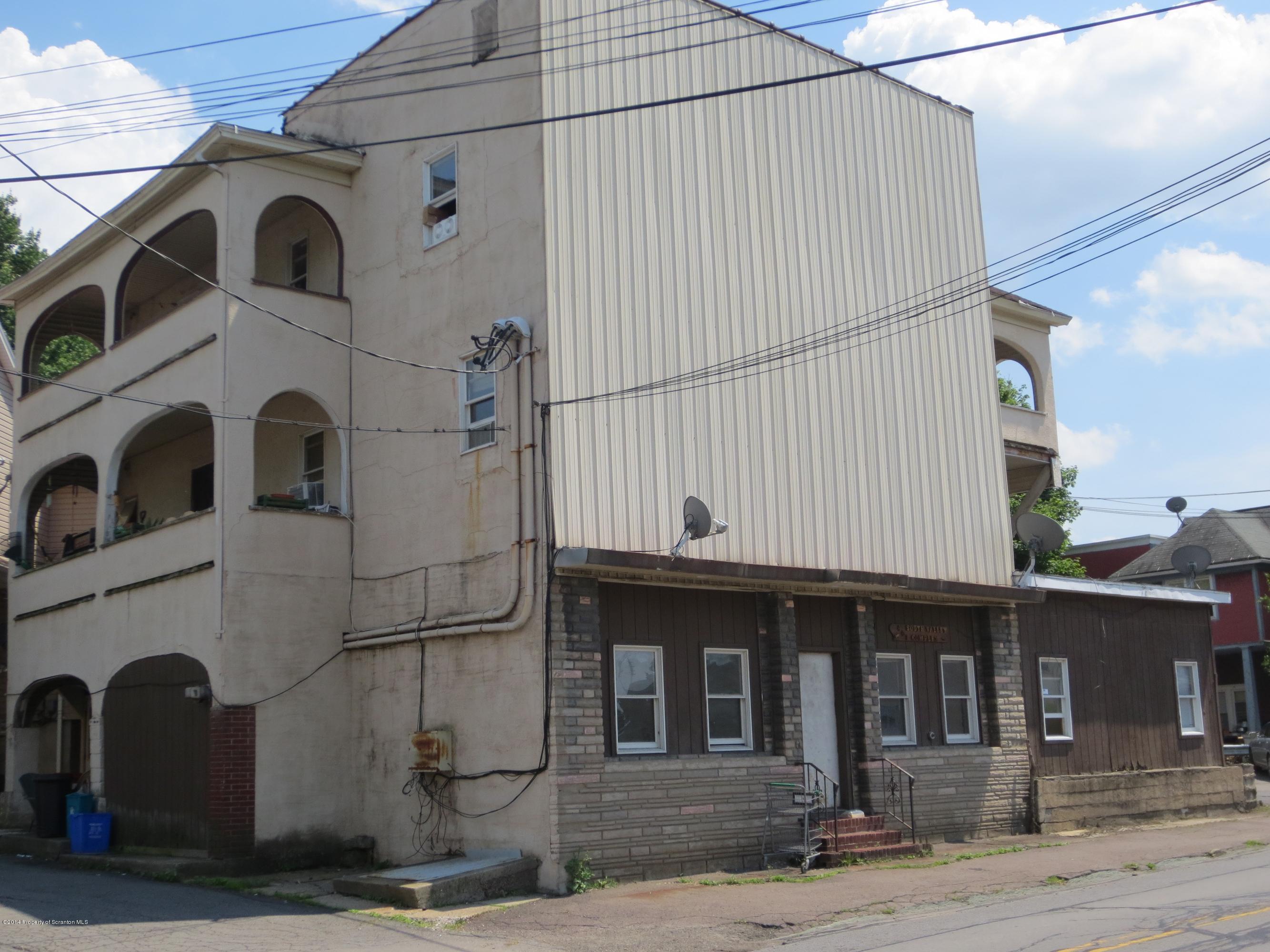 401 South Valley Avenue Olyphant, PA 18447 - Photo 2 of 4 a front view of a residential apartment building with a yard