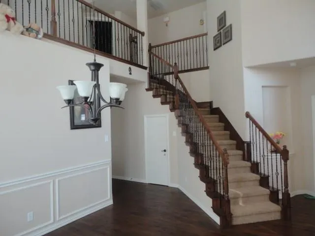 a view of a workspace with furniture and wooden floor