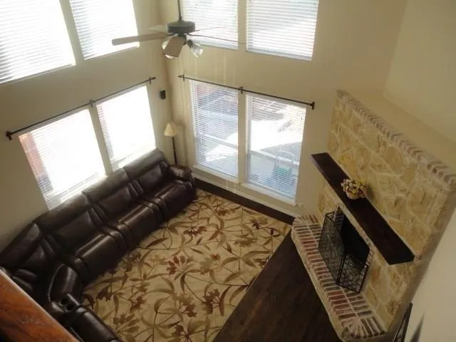 a living room with furniture and a ceiling fan