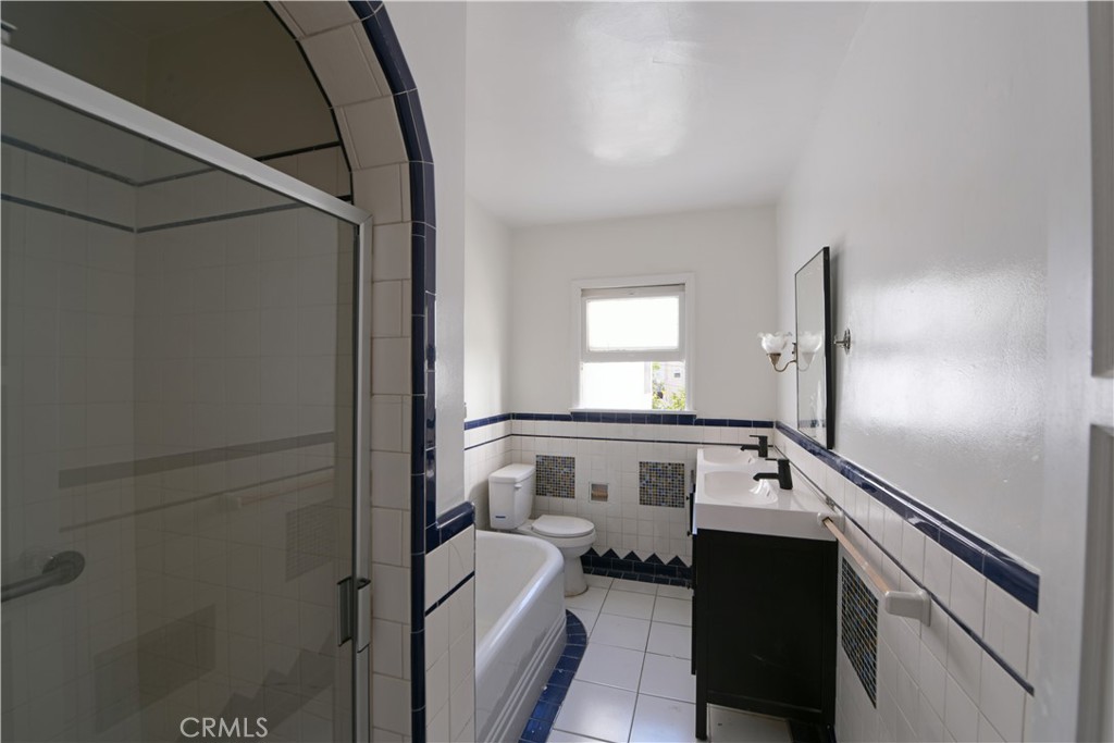 915 Le Doux Road Los Angeles, CA 90035 - Photo 13 of 30 a bathroom with a tub sink and mirror