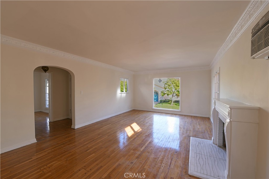 915 Le Doux Road Los Angeles, CA 90035 - Photo 2 of 30 an empty room with wooden floor and windows