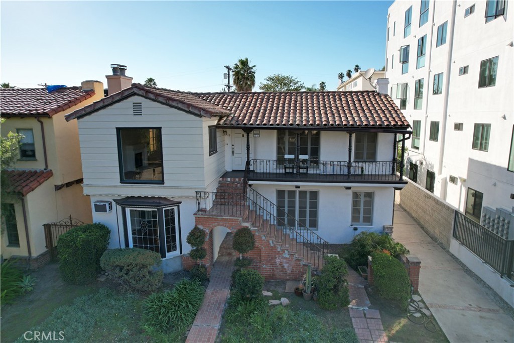 915 Le Doux Road Los Angeles, CA 90035 - Photo 22 of 30 a view of a house with brick walls and a yard