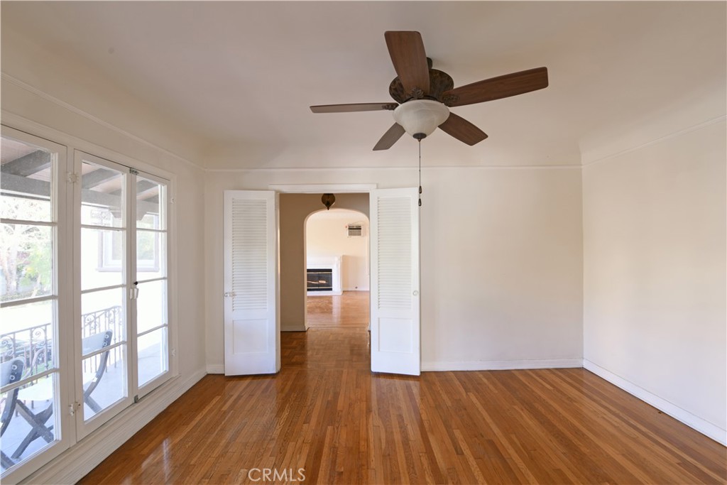 915 Le Doux Road Los Angeles, CA 90035 - Photo 3 of 30 a view of empty room with wooden floor and fan