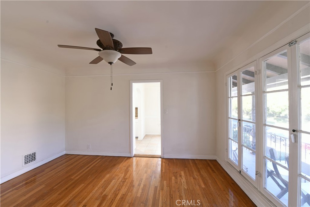 915 Le Doux Road Los Angeles, CA 90035 - Photo 6 of 30 a view of empty room with wooden floor and fan