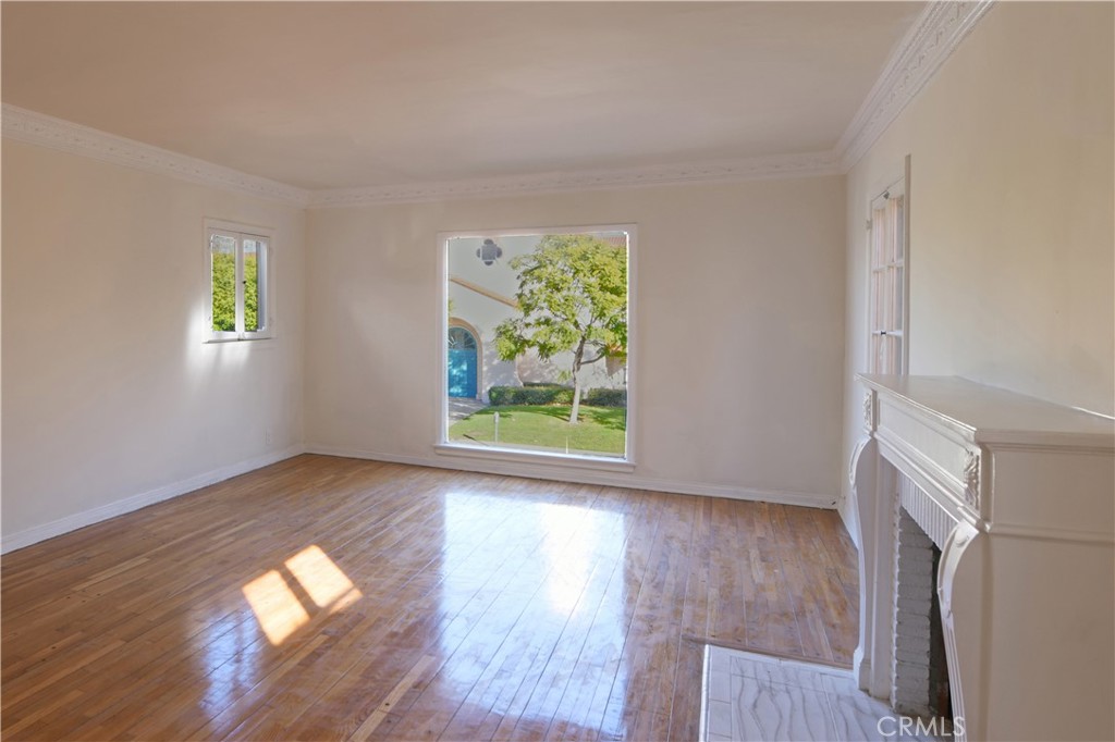 915 Le Doux Road Los Angeles, CA 90035 - Photo 7 of 30 a view of empty room with wooden floor and fan