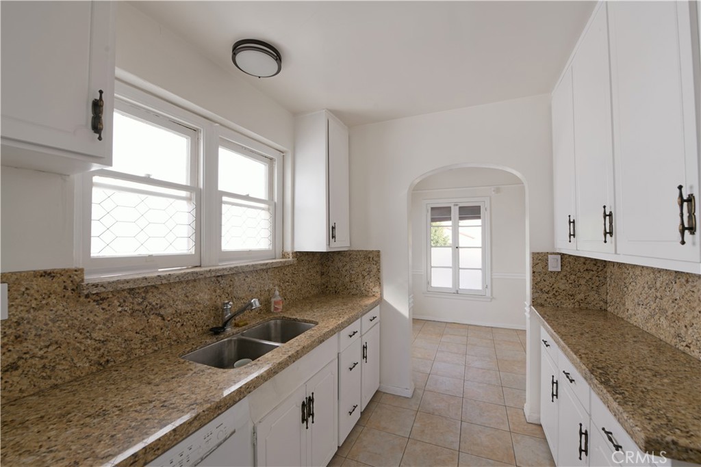 915 Le Doux Road Los Angeles, CA 90035 - Photo 9 of 30 a kitchen with granite countertop a sink and a stove