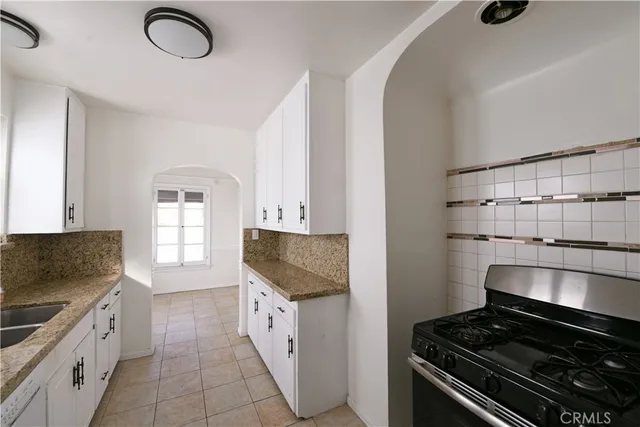 a kitchen with granite countertop cabinets and steel stainless steel appliances