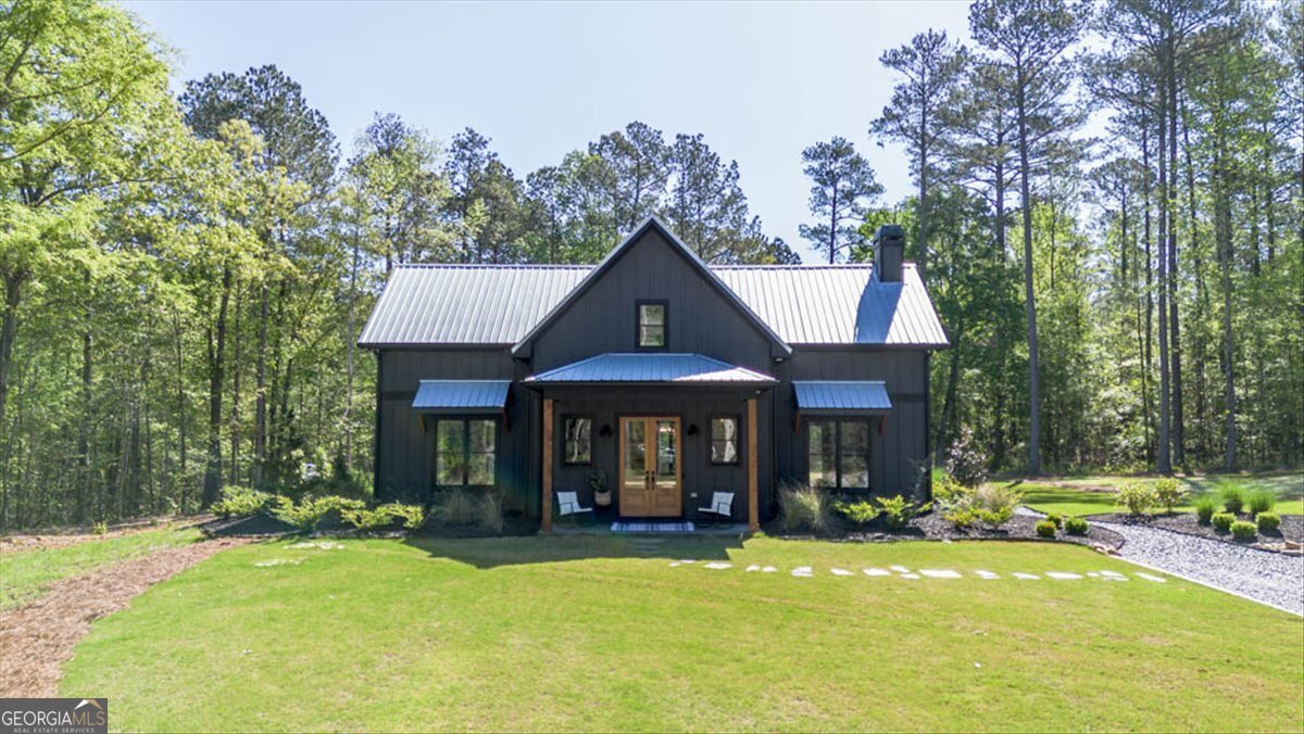 a view of a house with swimming pool and sitting area