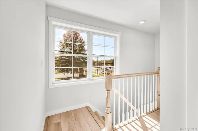 a view of a room with wooden floor and windows