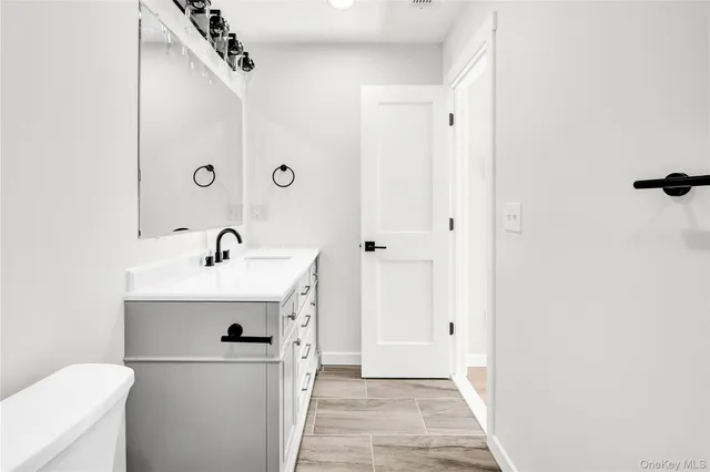a view of a bathroom with a sink and mirror