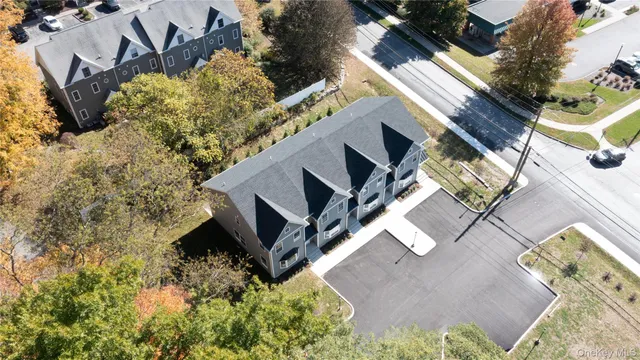 an aerial view of a house with a yard