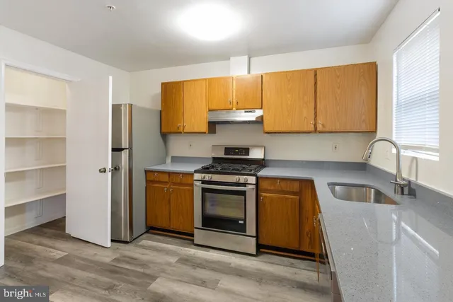 a kitchen with a sink stove and cabinets