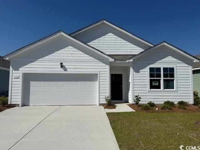 552 Duvall Street Longs, SC 29568 - Photo 1 of 16 View of front of home featuring a garage, driveway, and a front lawn