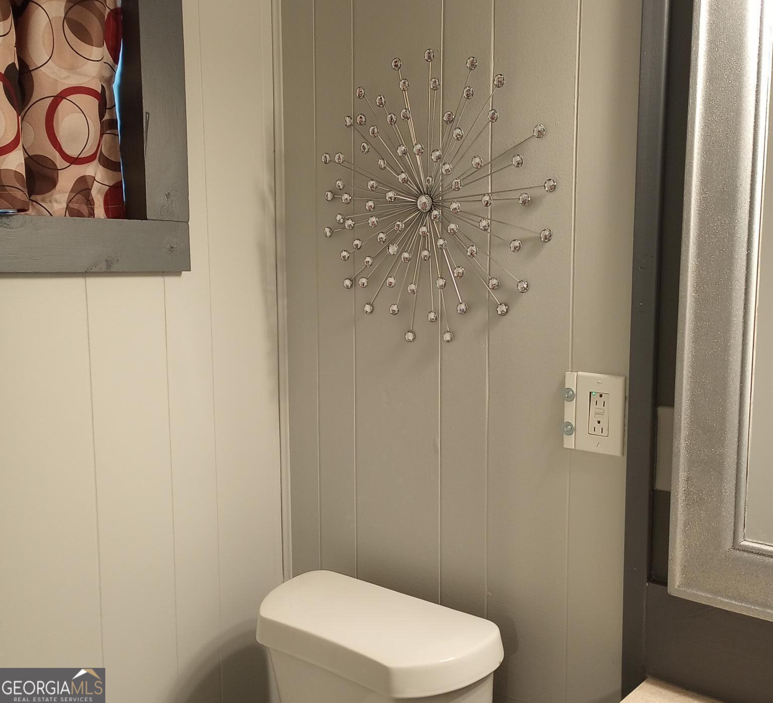 364 Pleasant Valley Road Southeast Silver Creek, GA 30173 - Photo 15 of 18 a white toilet sitting next to a shower curtain