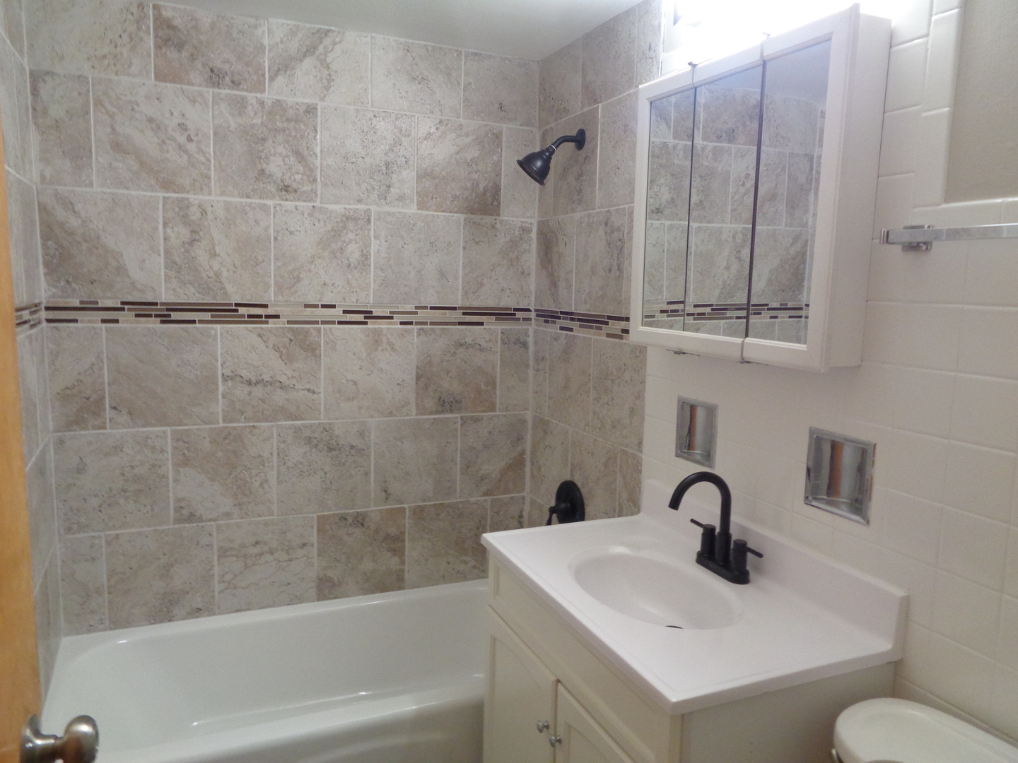 5818 107th Ct Way, Unit 10 Chicago Ridge, IL 60415 - Photo 7 of 7 a bathroom with a sink a toilet and shower