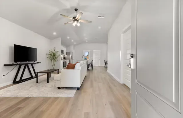 a living room with furniture and a flat screen tv