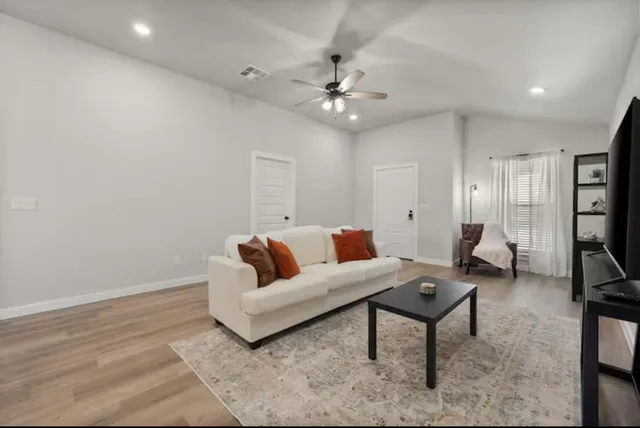 a living room with furniture and a chandelier