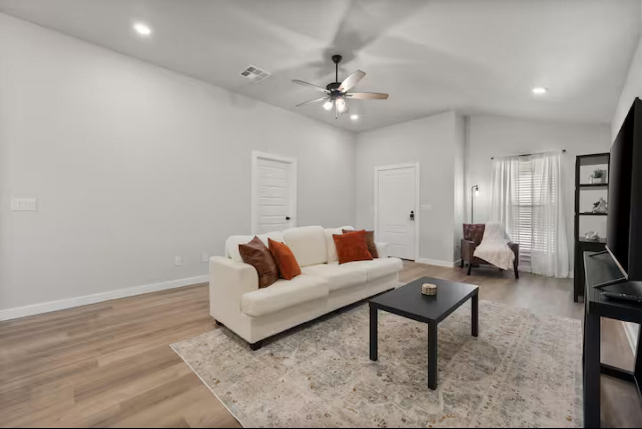 3518 Turner Avenue Lubbock, TX 79407 - Photo 3 of 12 a living room with furniture and a chandelier