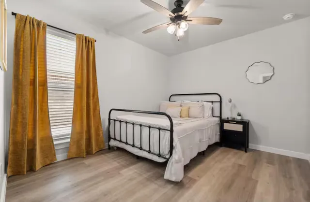 a bedroom with a bed and a chandelier