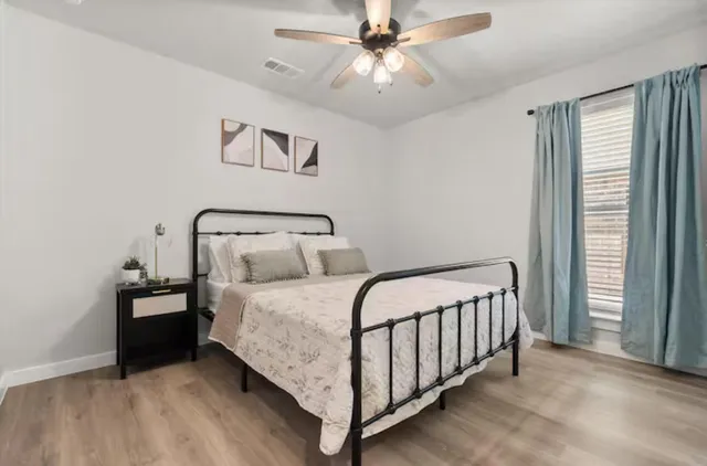 a bedroom with a bed and window