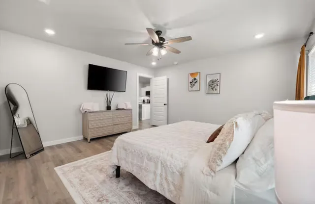 a bedroom with a bed and a flat screen tv