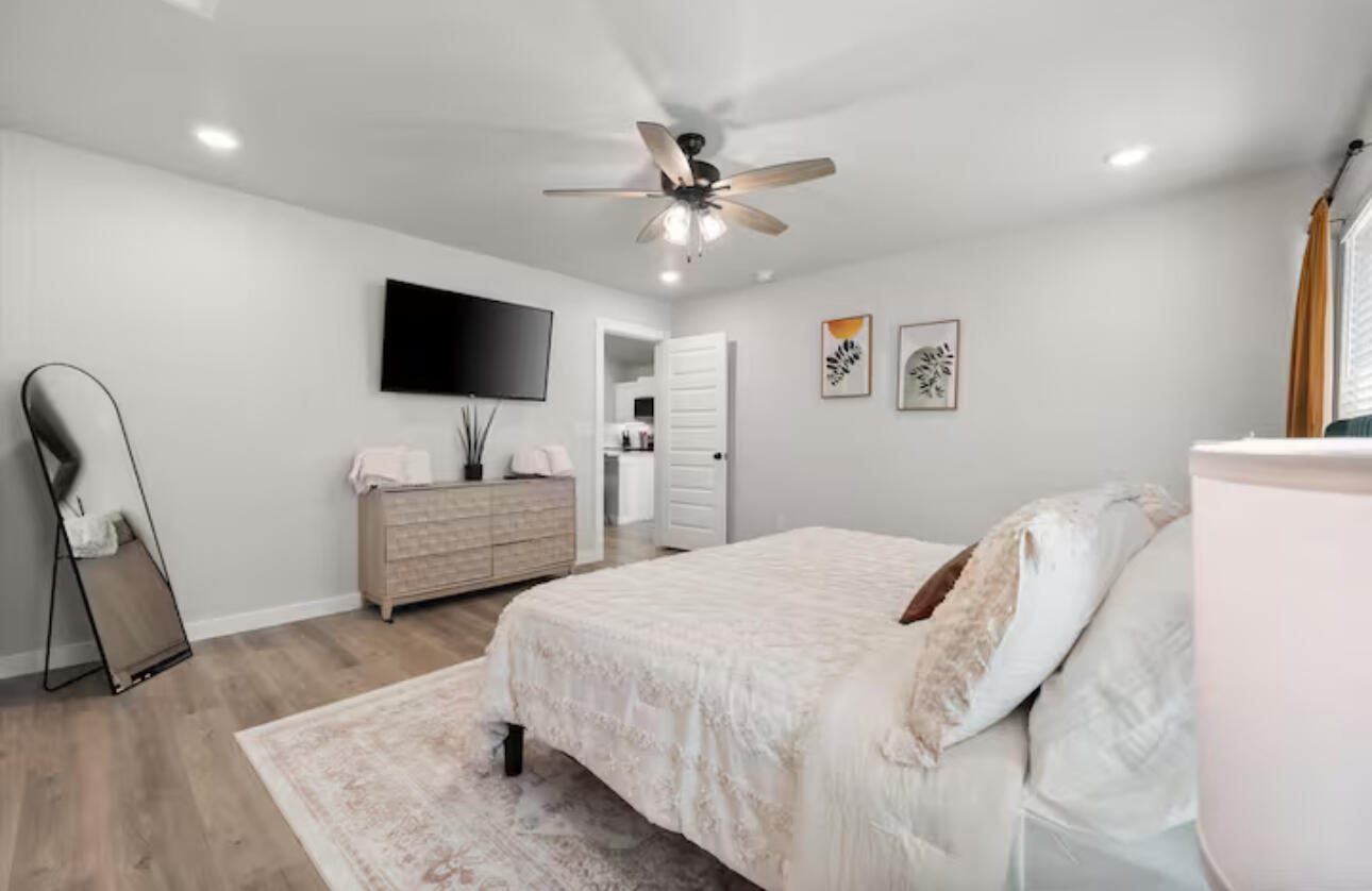 3518 Turner Avenue Lubbock, TX 79407 - Photo 9 of 12 a bedroom with a bed and a flat screen tv