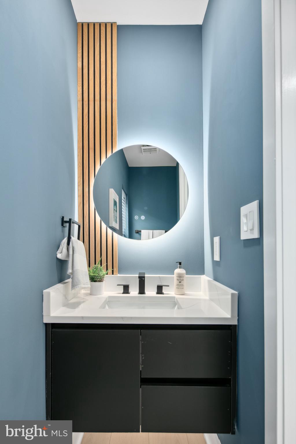 655 Morton Place Northeast, Unit 1 Washington, DC 20002 - Photo 11 of 26 a bathroom with a sink and a mirror