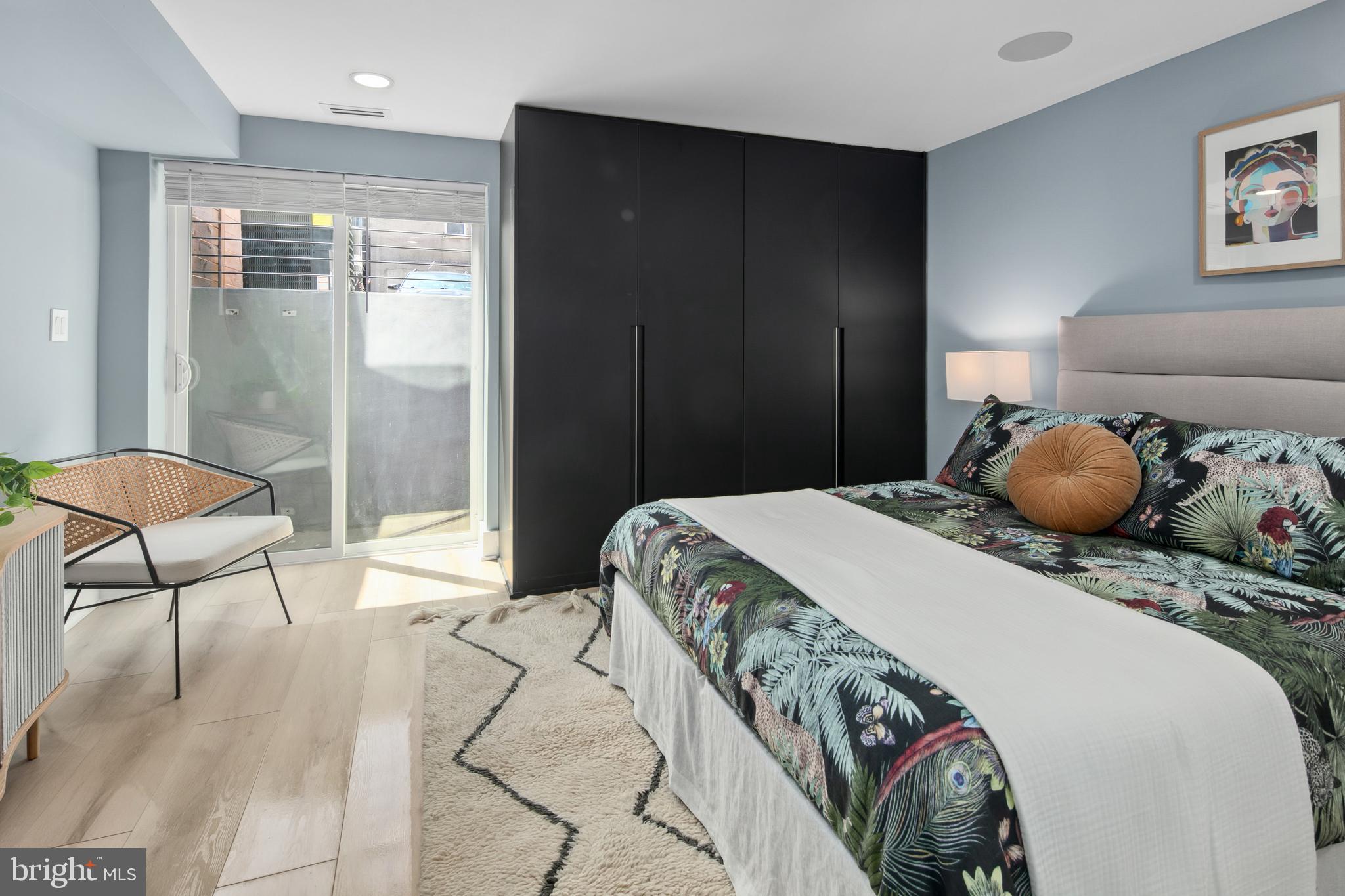 655 Morton Place Northeast, Unit 1 Washington, DC 20002 - Photo 13 of 26 a bedroom with a bed and a lamp