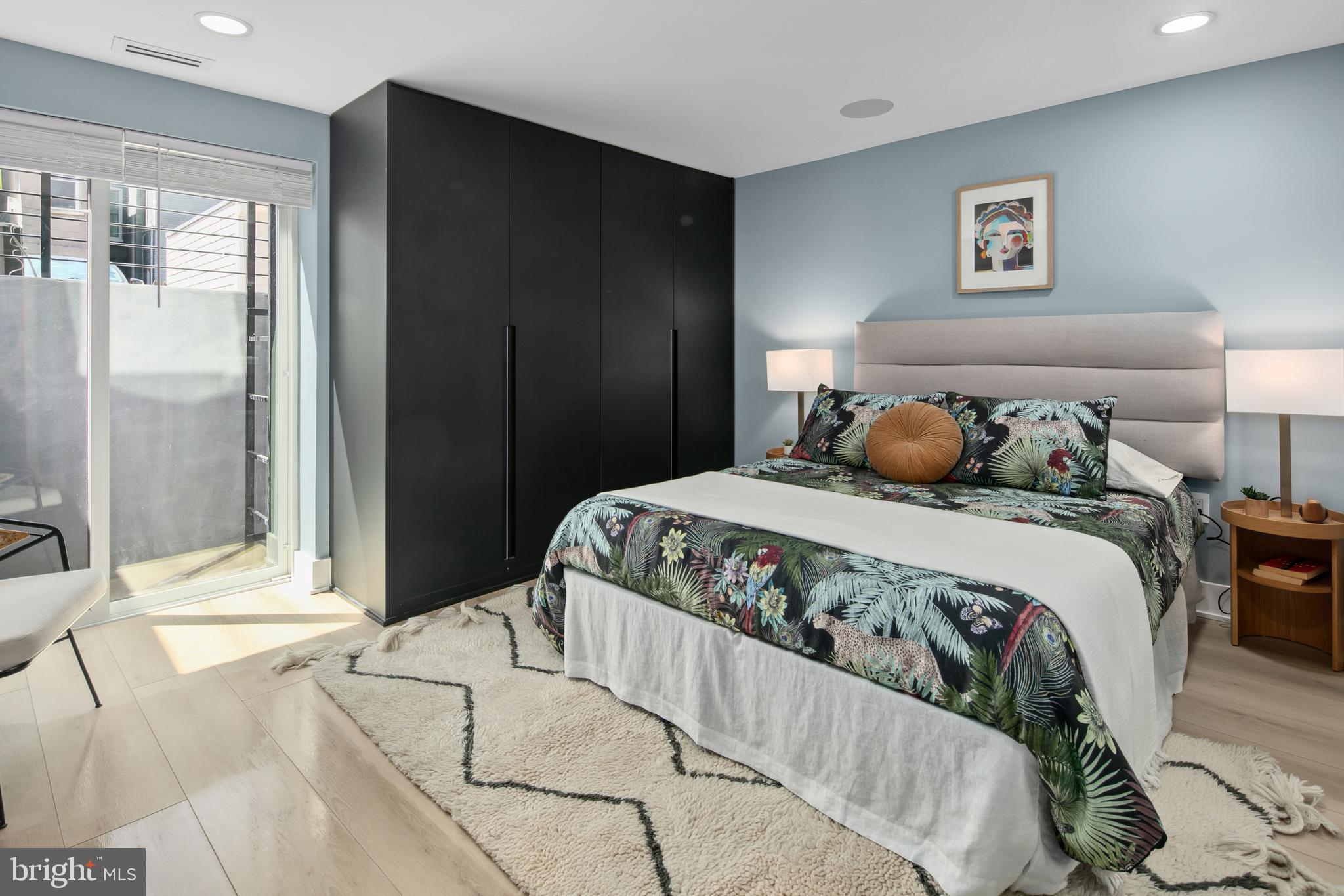 655 Morton Place Northeast, Unit 1 Washington, DC 20002 - Photo 14 of 26 a bedroom with a large bed and a large mirror